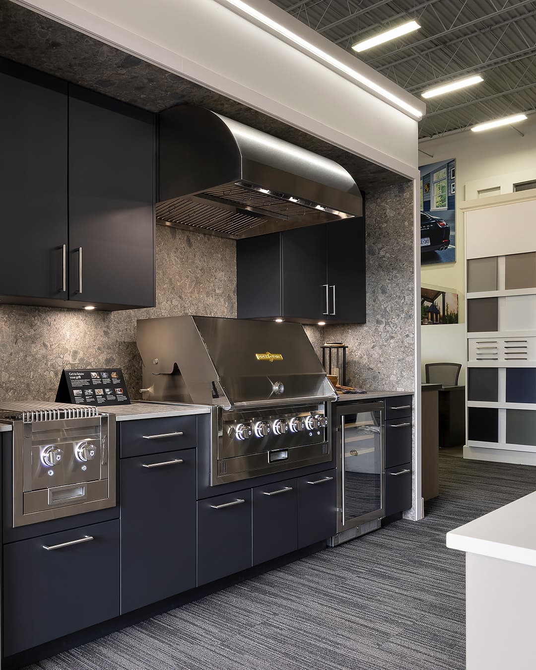Crown Verity grill, range hood, refrigerator and side grill with blue Alumina cabinetry